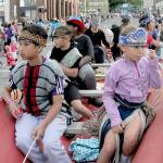 Children from the Lower Elwha Klallam Tribe ride in a canoe being trailered as the tribes July 4 parade entry. (Keith Thorpe/Peninsula Daily News)