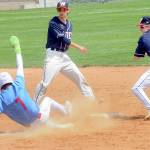 KEITH THORPE/PENINSULA DAILY NEWS Kingstons Connor Oase slides into second after being forced out by Wilder Juniors Zach DeBray, right, after a short toss from shortshop Bryce DeLeon for the first leg of a double play on Saturday at Port Angeles Civic Field.