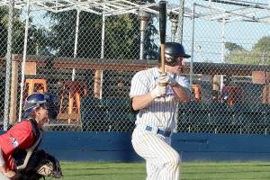Dave Logan/for Peninsula Daily News
Port Angeles' Tyler  Shulman gets a base hit with his turn at the plate in the first inning.