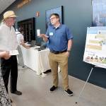 KEITH THORPE/PENINSULA DAILY NEWS
Thomas Praisewater, a site manager with the Washington Dept. of Ecology, right, discusses environmental cleanup sites with Madelynne Jones, left, and Thomas Beatty, both of Port Angeles, during an open house on the status cleanup of the former Rayonier mill site on Tuesday at the Field Arts & Events Hall.
