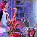 Levi Gillis, the saxophonist for The Sky Is A Suitcase, plays during a concert on July 5. (Elijah Sussman/Peninsula Daily News)