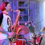 Levi Gillis, the saxophonist for The Sky Is A Suitcase, plays during a concert on July 5. (Elijah Sussman/Peninsula Daily News)