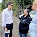 Gov. Bob Ferguson, left, speaks with Lower Elwha Klallam Tribal Chairwoman Frances Charles and Vice Chair Russ Hefner before a news conference on Sunday at the confluence of Indian Creek and the Elwha River after a fuel spill into the creek on Friday forced a shutdown of the Port Angeles municipal water system. (Keith Thorpe/Peninsula Daily News)