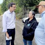 Gov. Bob Ferguson, left, speaks with Lower Elwha Klallam Tribal Chairwoman Frances Charles and Vice Chair Russ Hefner before a news conference on Sunday at the confluence of Indian Creek and the Elwha River after a fuel spill into the creek on Friday forced a shutdown of the Port Angeles municipal water system. (Keith Thorpe/Peninsula Daily News)