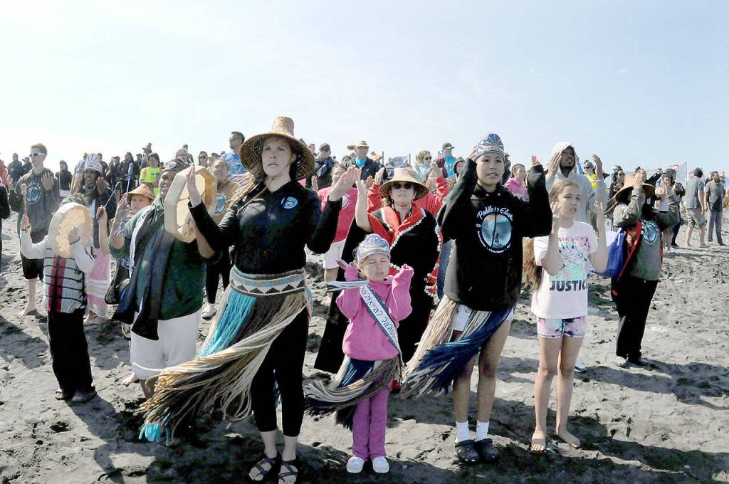 Greeters sing a welcome song to an arriving canoe on Thursday at Lower Elwha. (Keith Thorpe/Peninsula Daily News)
