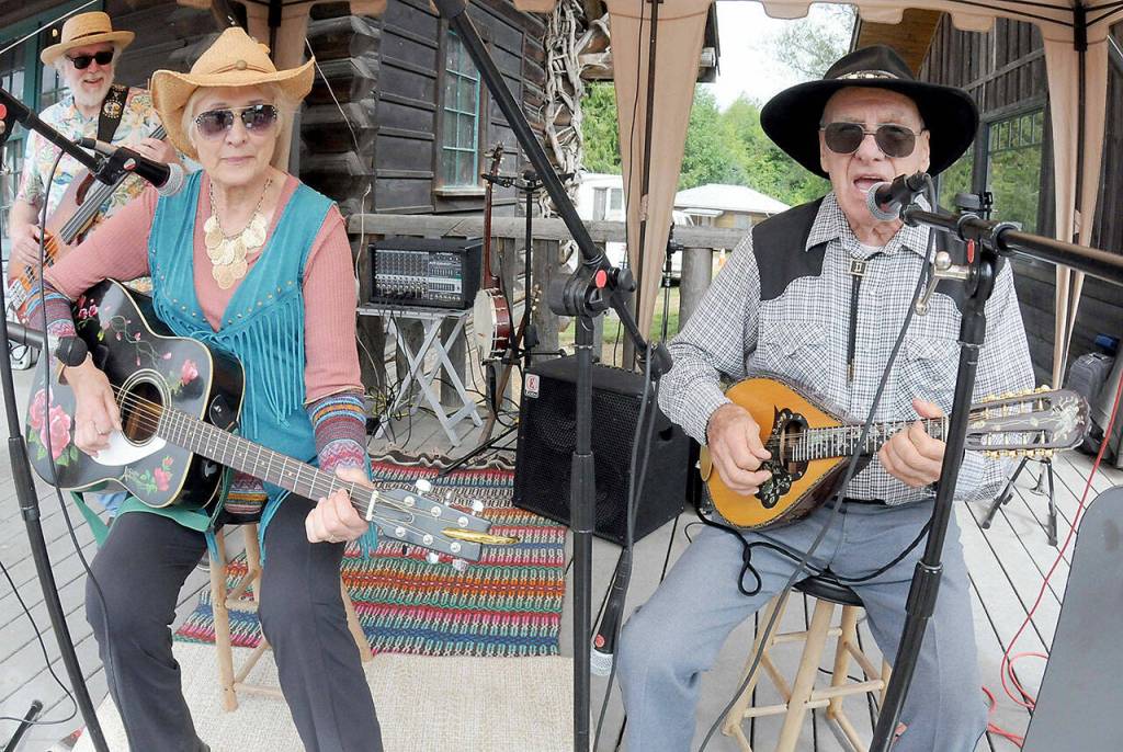 Rosalie and Dave Secord, longtime members of the old-time and bluegrass music group Luck of the Draw, perform at Saturdays Joyce Daze Wild Blackberry Festival in Joyce. The Secords, who have been festival music organizers and have performed at Joyce Daze since its inception 42 years ago, will retire from the event and turn musical direction over to others. (Keith Thorpe/Peninsula Daily News)