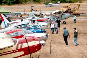 Spectators roam the grounds of Jefferson County International Airport looking over some of the historic airplanes on display during the second annual Jefferson County Airport Day on Saturday. (Steve Mullensky/for Peninsula Daily News)