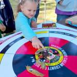 Maddie Rogers, 5, of Maddies Mushrooms in Joyce gives last-minute coaching to her slug Garth, which she trained for Saturdays annual Extreme Slug Racing event. (Shannon Turner)