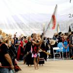 Quileute tribal member Devin Coberly-Black carries the tribes banner as dancers enter the performance area at the Paddle to Elwha 2025 celebration on Tuesday at the Lower Elwha Klallam Tribal Reservation west of Port Angeles. Native bands from around the region took part in the five-day event following the arrival of dozens of tribal canoes last Thursday. Festivities concluded on Tuesday with traditional dances and songs by native groups from across the Peninsula. (Keith Thorpe/Peninsula Daily News)