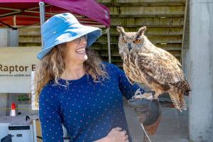 Abby Dugle of Sebastopol, Calif., holds Marvin, a Eurasian eagle owl, during a Raptor Experience at the Jefferson County Fair on Friday. Dugle paid $50 for the experience of holding the raptor that is used as a stand-in for great horned owls due to their resemblance. Dugle described the experience as wonderful and exciting. The Raptor Experience will be showing other raptors today and Sunday during the fair. (Steve Mullensky/for Peninsula Daily News)