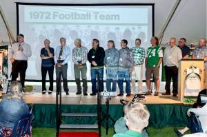 The 7th annual Port Angeles Hall of Fame induction ceremony was held Saturday night on the grass at Civic Field. More than 350 people attended the event held under a tent. Nine individuals were inducted as well as three teams — the 1977 girls basketball, 1972 football, and 1952 boys basketball teams. The nine individuals were Bob Blackburn, track; Mike Chamberlin, swimming; Gus Kravas, basketball; Steve Johansen, basketball; Jodie Jones, softball; Bob Lovell, football; Adam Macomber, football; Bob Spencer, swimming; and Susan Wilson Childers, badminton. Here, Jerry Payne, far left, speaks for the 1972 football team that was ranked as high as fifth in the state and had seven shutouts in 10 games. (Photos by Dave Logan/for Peninsula Daily News)