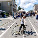 Quinn Early, 6, of Port Townsend, spins five hula hoops at once during the 33rd Uptown Port Townsend Street Fair on Saturday. (Steve Mullensky/for Peninsula Daily News)
