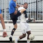 KEITH THORPE/PENINSULA DAILY NEWS Rogues Sammy Bayer, left, tries to go up and over Peninsulas Austin Collins on Friday at Peninsula College.