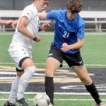 KEITH THORPE/PENINSULA DAILY NEWS Peninsulas Rei Sato, left, fends off Rogues Maximo Melgar-Martich during Fridays match in Port Angeles.