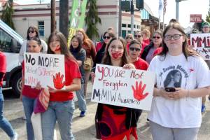 Participants in Mondays missing and murdered indigenous people (MMIP) march wore red and walked from the Elwha Klallam Heritage Center to the Port Angeles Gateway Transit Center. (Elijah Sussman/Peninsula Daily News)