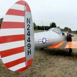 Josephine Camacho of Sequim examines a 1946 vintage Ercoupe 415-C belonging to Kevin and Charlene Tracy of Diamond Point as it sits on display during the Olympic Peninsula Air Affaire on Saturday at Sequim Valley Airport. The fly-in event featured modern and classic aircraft, as well and an antique auto show, displays, food and music. (Keith Thorpe/Peninsula Daily News)