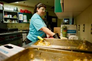 Kat Malcom, child nutrition director for the Sequim Boys & Girls Club, prepares chicken enchilada wraps for distribution to children throughout Sequim. During the months of June and July, the Boys & Girls Clubs of the Olympic Peninsula provided more than 16,000 meals and snacks to children in Sequim and Port Angeles. (Jacques Star/Olympic Peninsula News Group)