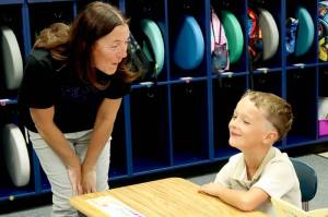 Jefferson Elementary School first-grade teacher Pamela Miller welcomes Ethan Puderbaugh to the classroom as school started Tuesday in the Port Angeles School District. Port Townsend and Chimacum schools also began Tuesday while classes in the Quillayute Valley and Cape Flattery school districts start today. The Quilcene and Brinnon school districts began Aug. 25 while Sequim and Crescent schools began Aug. 27. (Dave Logan/for Peninsula Daily News)