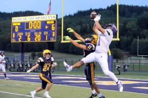 This Sequim pass to the Wolves Liam Wiker, No. 11 in white, was deflected by Forks Cash Barajas, No. 11 in navy blue, then intercepted by the Spartans Kingston Steffen and returned out to midfield. The Wolves held on in the closing moments for an 18-14 win on the Spartan Stadium turf.
Lonnie Archibald/for Peninsula Daily News.