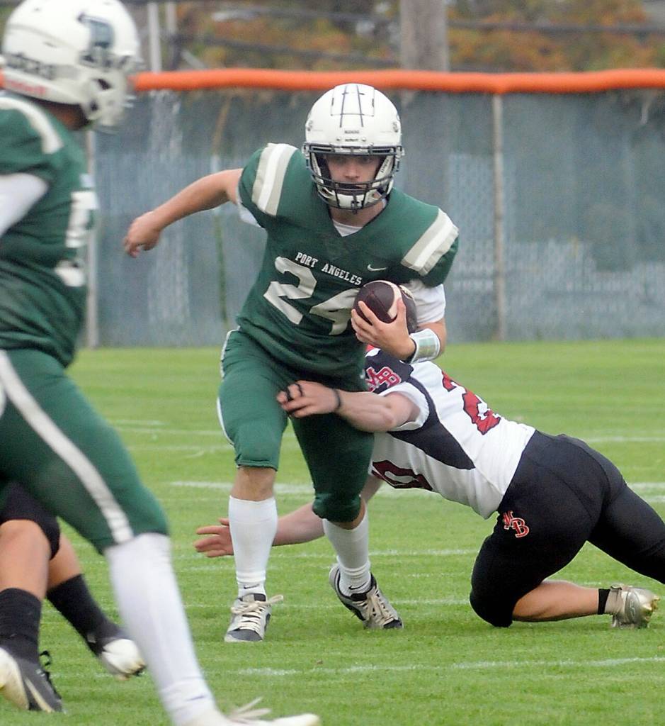 KEITH THORPE/PENINSULA DAILY NEWS
Port Angeles quarterback Jude Wallace tries to evade the defense of Mount Baker's Andrew Montieith in Friday's non-conference game at Port Angeles Civic Field.