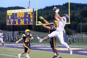 This Sequim pass to Liam Wiker (11) was deflected by Forks Cash Barajas (11) then intercepted by Forks Kingston Steffen (24). The Wolves held on in the closing moments for an 18-14 victory. (Lonnie Archibald/for Peninsula Daily News)