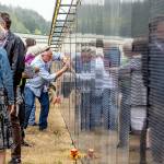 Frank Arey of Port Hadlock rubs his uncle Stephen R Lopemans name that is etched in the three-quarter scale Vietnam Veterans Memorial on display at Jefferson County International Airport until 2 p.m. Sunday. Lopeman, a 1968 Port Townsend High School graduate, died in Vietnam in 1969. (Steve Mullensky/for Peninsula Daily News)