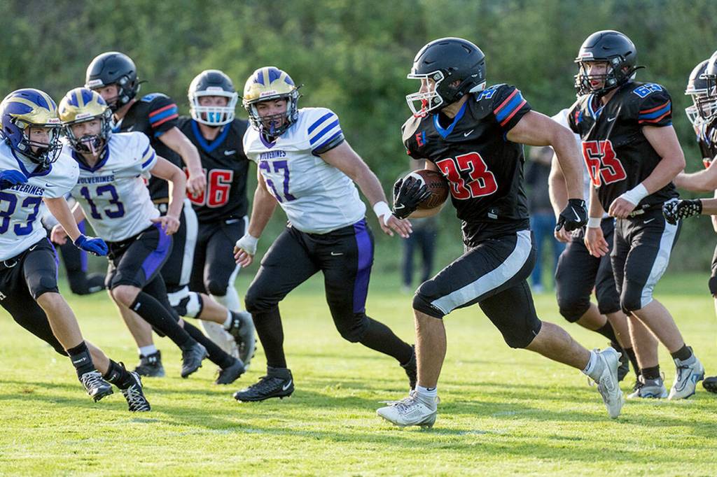 Steve Mullensky/for Peninsula Daily News

Rivals' Luke O'Hara runs a gauntlet of Wolverine defenders during a Friday night non-league game played against Friday Harbor in Port Townsend's Memorial Field.