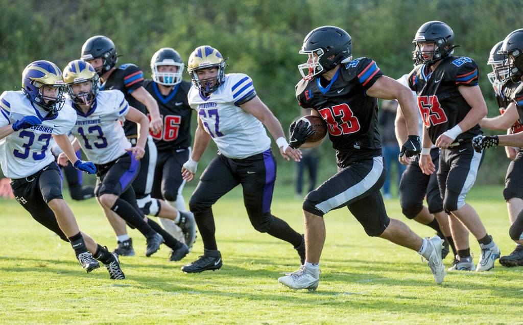 Steve Mullensky/for Peninsula Daily News

Rivals' Luke O'Hara runs a gauntlet of Wolverine defenders during a Friday night non-league game played against Friday Harbor in Port Townsend's Memorial Field.