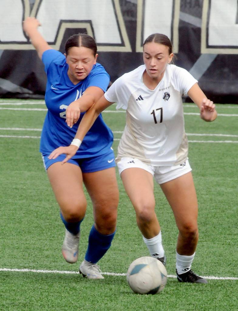 Edmonds Aliya Boonsripisal, left, and Peninsulas Emma Crystal give chase to the ball on Saturday afternoon in Port Angeles. (Keith Thorpe/Peninsula Daily News)