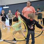 Youth Development staffer Aymon Anderson leads a group of elementary school children in a hula hoop challenge as part of the Sequim Boys & Girls Clubs Project L.A.N.E. (Boys & Girls Clubs of the Olympic Peninsula)