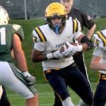 Forks tight end Kaden Ward, center, scrambles for a way past Port Angeles Hunter Flores as teammate Conner Roberts, right, sets up a block on Friday evening in Port Angeles. (Keith Thorpe/Peninsula Daily News)