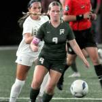 Port Angeles Allison Fricker, front, approaches the ball ahead of Bainbridges Isabella Saint Clair on Tuesday night at Peninsula College. (Keith Thorpe/Peninsula Daily News)