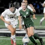 Port Angeles Stella Fradkin, right, works to outrun Bainbridges Isabella Saint Clair, left, and Isla Buffkin on Tuesday night in Port Angeles. (Keith Thorpe/Peninsula Daily News)