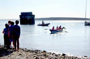 A group of fifth-graders from The Evergreen School in Shoreline launches a boat they built as a part of a week-long Northwest Maritime program. (Elijah Sussman /Peninsula Daily News)