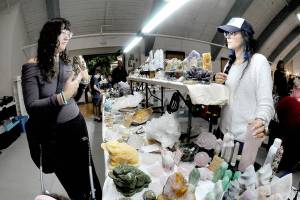Julianna Milles of Sequim, left, and Tama Juarez of Seattle-based Inchel Crystals discuss jewelry at the 2025 Rock, Gem and Jewelry Show on Saturday at the Vern Burton Community Center in Port Angeles. The two-day event, hosted by the Clallam County Gem & Mineral Association, featured numerous vendors offering a selection of gems, rocks, fossils, crystals, beads and finished jewelry. (Keith Thorpe/Peninsula Daily News)