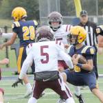 Forks quarterback Lane Helvey looks for room to run the ball against Kittitas on Saturday in Forks. (Lonnie Archibald/for Peninsula Daily News)
