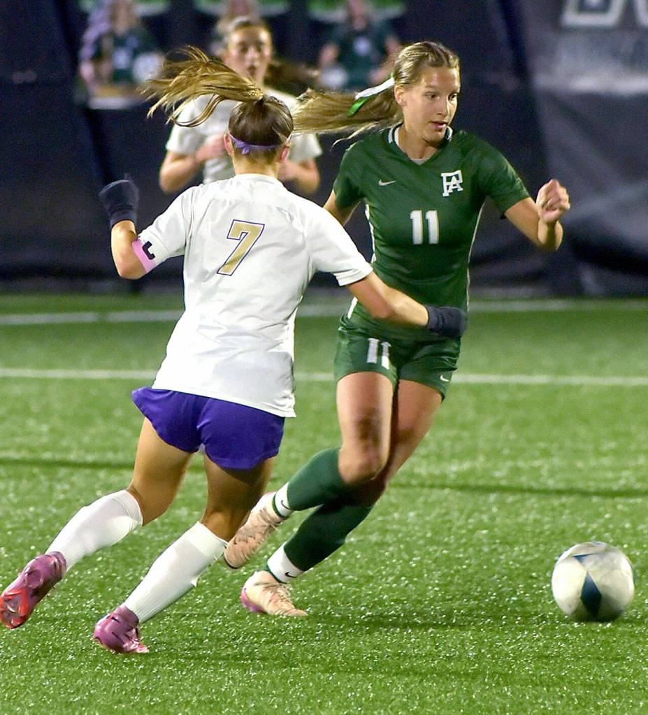 KEITH THORPE/PENINSULA DAILY NEWS
Port Angeles' Morgan Politika, right, charges past Sequim's (#7) during Thursday night's match in Port Angeles.