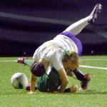 KEITH THORPE/PENINSULA DAILY NEWS
Port Angeles' Teanna Clark hits the pitch as Sequim's (#14) tumbles on top of her for a penalty on Thursday night at Peninsula College.