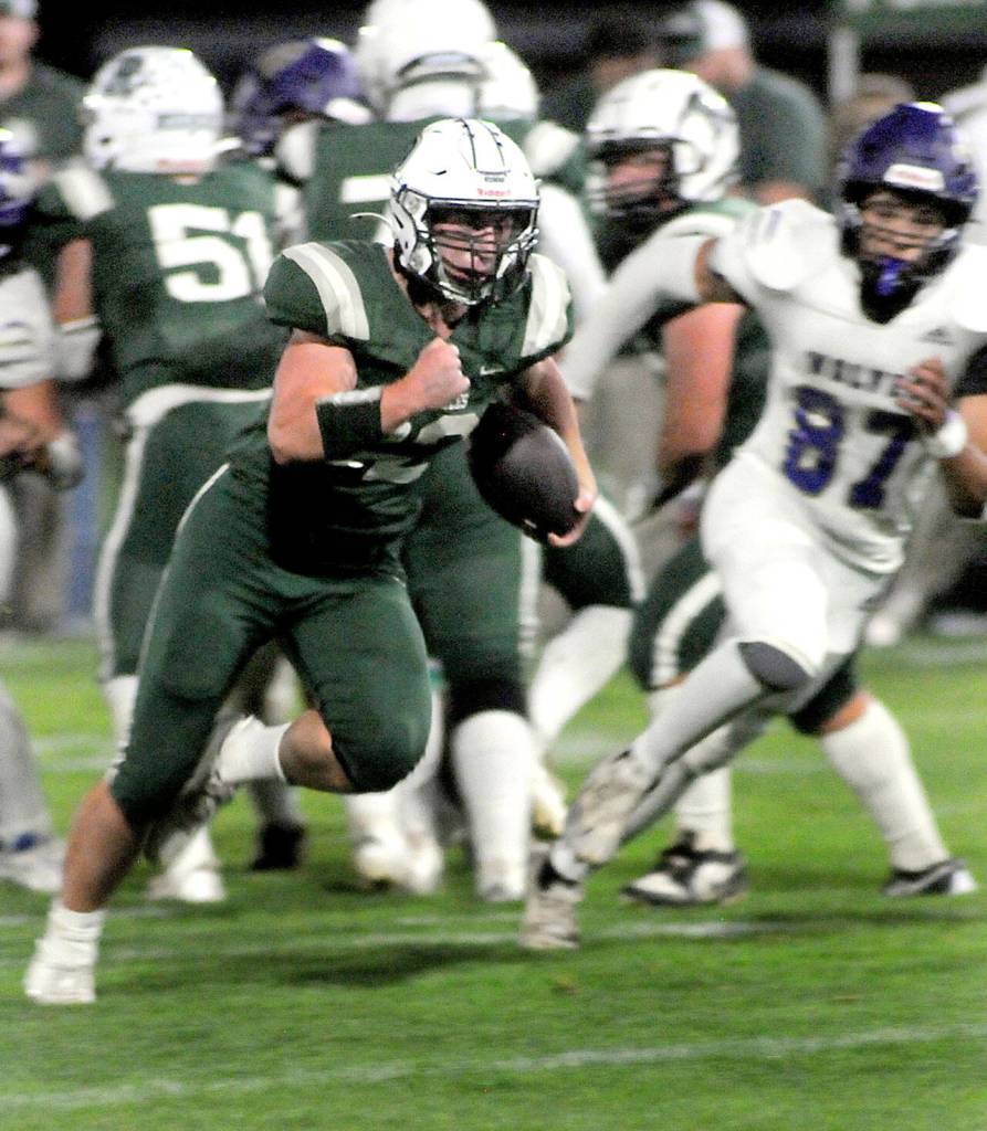 KEITH THORPE/PENINSULA DAILY NEWS Port Angeles Dylan Mann, center, squeezes past the Sequim defense on Friday in Port Angeles.