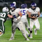 KEITH THORPE/PENINSULA DAILY NEWS
Sequim's Liam Walker, right, takes the handoff from quarterback Kaden Miller and looks for a break in the defensive line, including Port Angeles' Quinn Messersmith, left, and Sequim's Eli Miller on Friday at Port Angeles Civic Field.