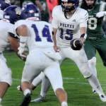 KEITH THORPE/PENINSULA DAILY NEWS Sequim quarterback Kaden Miller prepares to hand off to teammate Liam Wiker, left, protected by Zeke Schmadeke as Port Angeles Taylor Abold closes in during Fridays game in Port Angeles.