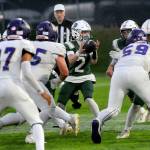 KEITH THORPE/PENINSULA DAILY NEWS
Port Angeles quarterback Carson Waddell, center, receives the shotgun as he looks through the Sequim defensive line for an opening on Friday evening in Port Angeles.