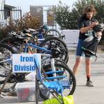 KEITH THORPE/PENINSULA DAILY NEWS
Big Hurt iron man competitor Joey Gish of Sequim stows his bicycle before heading to his kayak after finishing the mountain bike leg of the race in first place on Saturday at Pebble Beach Park in Port Angeles. Gish finished second in the iron division in the 2024 Big Hurt.