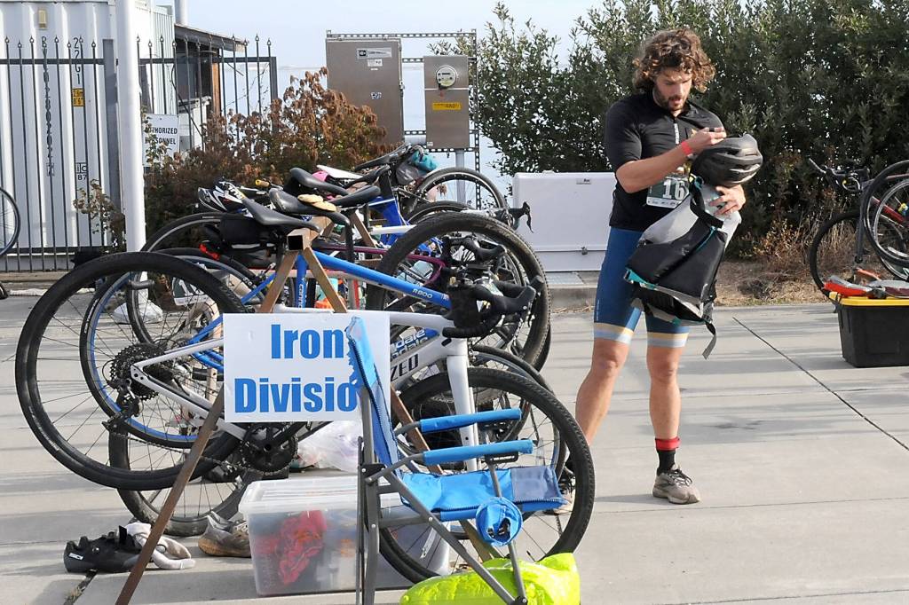 KEITH THORPE/PENINSULA DAILY NEWS
Big Hurt iron man competitor Joey Gish of Sequim stows his bicycle before heading to his kayak after finishing the mountain bike leg of the race in first place on Saturday at Pebble Beach Park in Port Angeles. Gish finished second in the iron division in the 2024 Big Hurt.