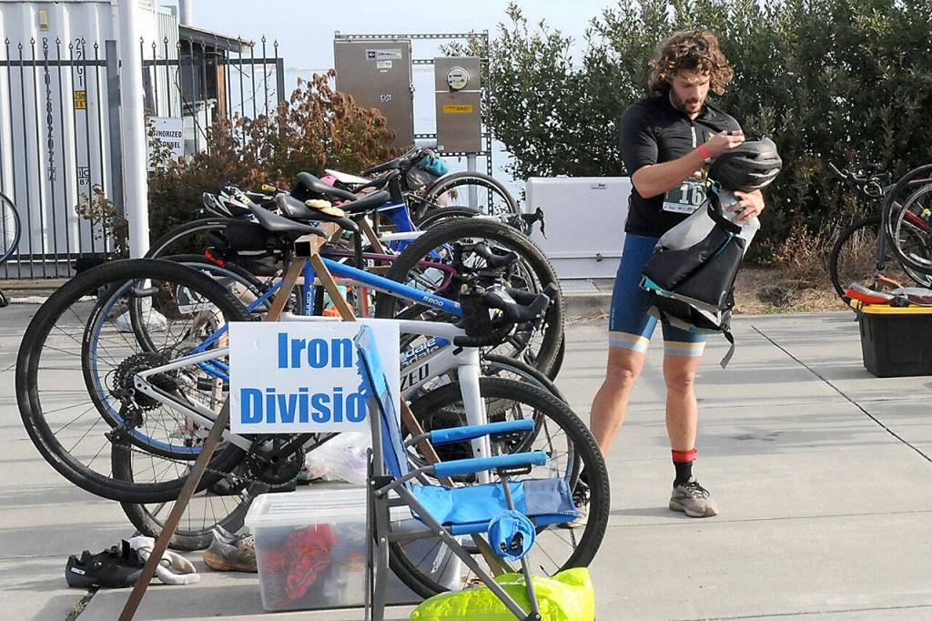 KEITH THORPE/PENINSULA DAILY NEWS
Big Hurt iron man competitor Joey Gish of Sequim stows his bicycle before heading to his kayak after finishing the mountain bike leg of the race in first place on Saturday at Pebble Beach Park in Port Angeles. Gish finished second in the iron division in the 2024 Big Hurt.