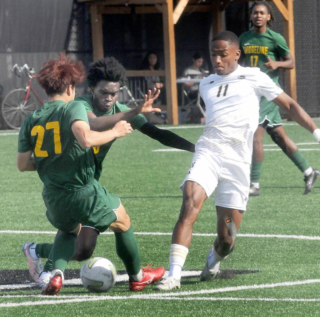 KEITH THORPE/PENINSULA DAILY NEWS Peninsulas Austin Collins, right, interrupts the pass between Shorelines Taiga Sannomiya, left, and Adjinon Alowakinnou on Saturday at Wally Sigmar Field.