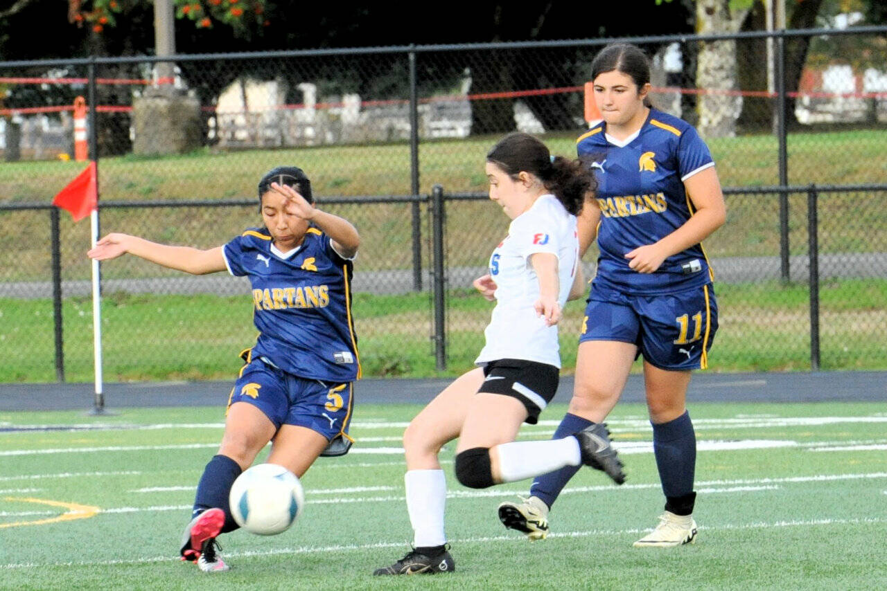 Forks Kim Camacho controls the ball in Forks while teammate Kendyl Woody is on the play against East Jeffersons Paula Ibarra. Forks won the game against an East Jefferson JV squad 7-0. (Lonnie Archibald/for Peninsula Daily News)