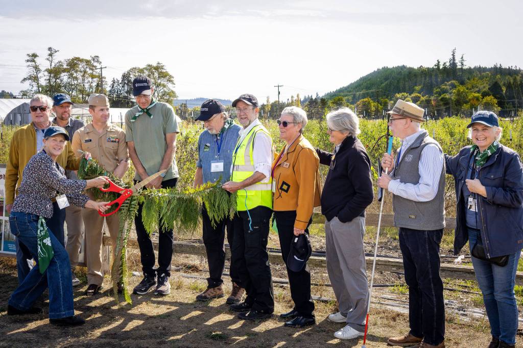 Cutting the ribbon at Finnriver Farm & Cidery to officially open Chimacum Ridge Community Forest! From left: Jefferson Land Trusts Director of Conservation and Strategic Partnerships Sarah Spaeth; Washington State Representative Steve Tharinger; Jefferson Land Trusts Director of Stewardship and Resilience Erik Kingfisher; Commanding Officer, Naval Magazine Indian Island R.J. Jameson; Look to the Land campaign co-chair Phil Vogelzang; Jefferson Land Trust Board of Directors Secretary and former President Brian Rogers; Jefferson Land Trust Board of Directors Vice President and Chimacum Ridge Community Forest Board of Managers Chair Tim Lawson; Jefferson Land Trust Board of Directors President Jane Guiltinan; Look to the Land campaign co-chair Ellen Ferguson; Jefferson Land Trusts Executive Director Richard Tucker; Jefferson Land Trusts Director of Philanthropy Kate Godman. (Sara Kozak)