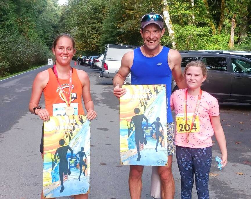 From left, Sarah Paquet of Bothell, John Mauro and Madeline Bartos-Mauro, both of Port Townsend, were all winners at the Spruce Railroad Trail 5K/10K. Paquet won the womens 10K while Mauro won the mens 10K. Bartos-Mauro, age 10, won her age 10-14 group. (Pierre LaBossiere/Peninsula Daily News)