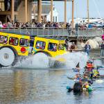 Racers make a big splash as they hit the water after rolling down the boat ramp at Northwest Maritime on Saturday. The 14 entrants in the Kinetic Skulpture race had to prove their floatability by paddling across the bay to the Port Townsend city dock, about a quarter-mile, and back to the ramp before they could participate in Sundays event. (Steve Mullensky/for Peninsula Daily News)